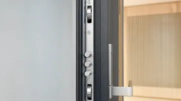 Crémone multipoints en acier sur le chant d'une porte de sécurité